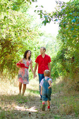 Fototapeta premium family on vacation with son together in green forest