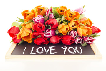Bunch of tulips with blackboard: I love you