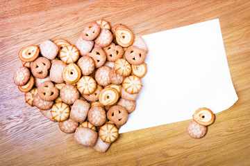 Shortbread heart with blank card on the wooden table