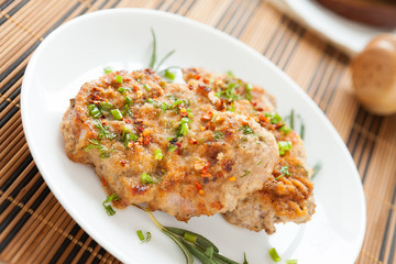 fried cutlet with chives on a white dish