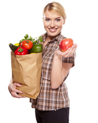 woman holding a bag full of healthy food. shopping .