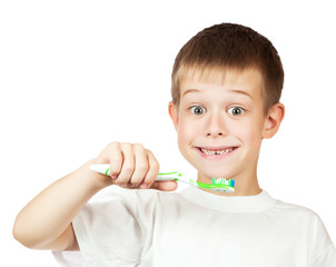 cheerful boy is brushing his teeth