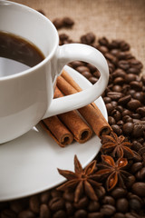 white cup of aromatic coffee with cinnamon