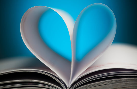 sign of heart with book pages on the blue