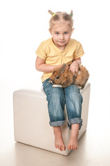 little girl playing with Easter bunny on a white background