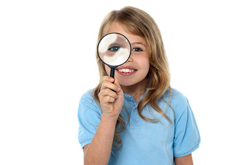Smiling kid with magnifying glass