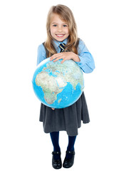 Aerial view of cute girl kid holding globe