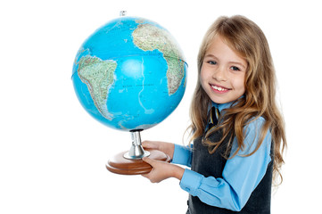Beautiful school going kid holding globe