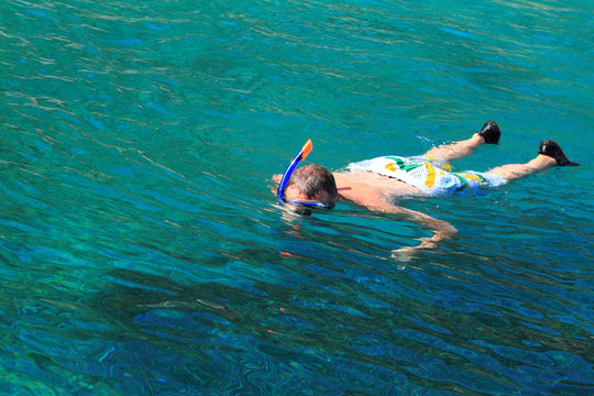 Young man is snorkeling