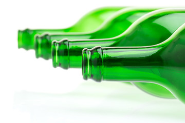 Liegende grüne Flaschen auf weißem Hintergrund