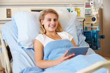 Teenage Female Patient In Hospital Bed With Digital Tablet
