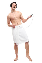Fototapeta premium Man wrapped in towel listening to music