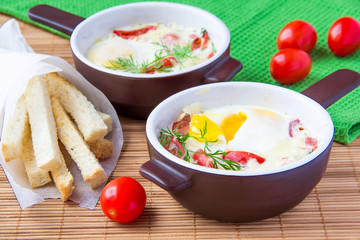 Baked eggs with cheese, tomatoes and croutons