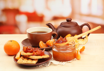 light breakfast with tea and homemade jam, on wooden table