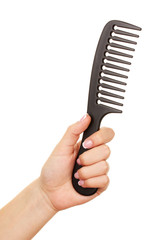Black comb in female hand isolated on white