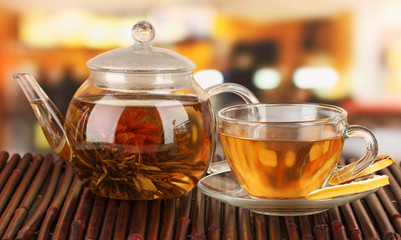Exotic green tea with flowers in glass teapot
