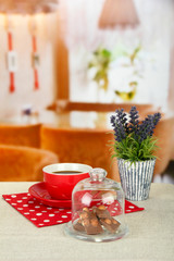 Fototapeta premium Chocolate pieces under glass cover and hot drink
