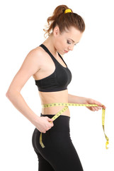 Woman measuring her waist isolated on white