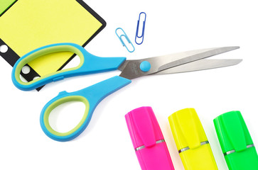 Scissor, Paper Clip, Stikers and Three Highlighter Pens on White