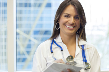 Hispanic doctor holding clipboard