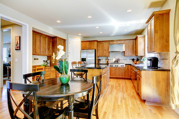 Wood classic large kitchen with granite island.
