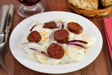 potato salad with fried sausages on the plate