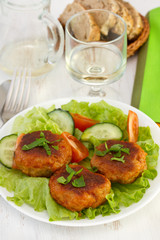 meatballs with salad on the plate and glass of wine