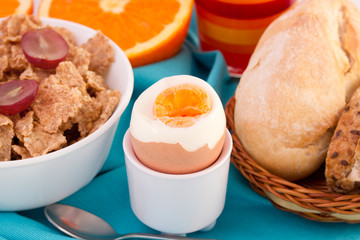 bread with boiled egg, cereals and juice
