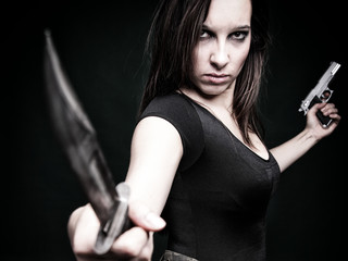 Sexy young woman long hair - gun knife