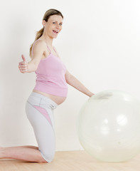 pregnant woman doing exercises with a ball