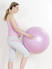 Fototapeta premium pregnant woman doing exercises with a ball