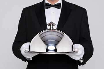 Waiter holding a silver cloche - 49266859