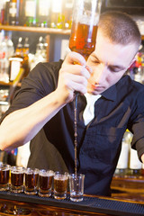 barman making  drink shots