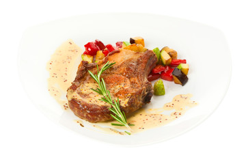 Grilled pork loin with vegetables on the plate