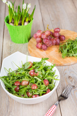 Fresh rucola salad with red grapes