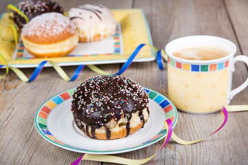 Chocolate and coconut donuts with carnival decoration.