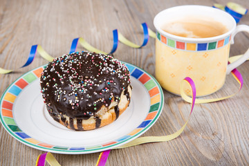 Chocolate and coconut donuts with carnival decoration.