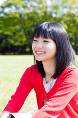 attractive asian woman relaxing in the park