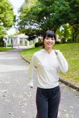 Fototapeta premium attractive asian woman jogging in the park