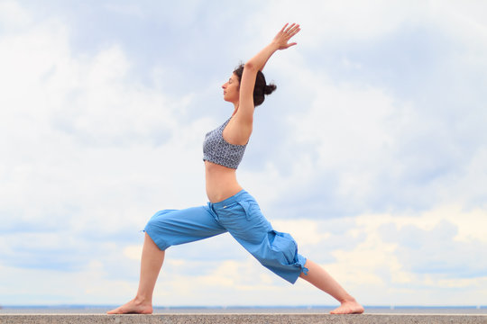Young woman doing yoga exrecises outdoors
