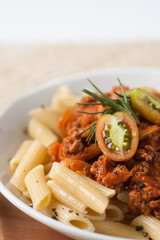 pasta penne bolognese with tomato and meat sauce