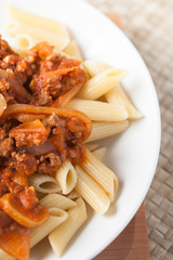 pasta penne bolognese with tomato and meat sauce