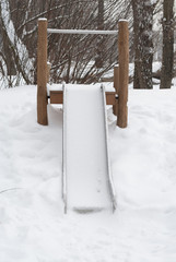 Empty Slide Covered in Snow.