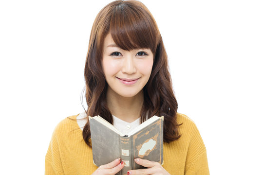 Beautiful asian woman readng a book on white background