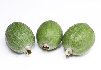 three feijoa on a white background