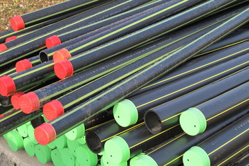piles of plastic pipes and conduits for transporting the  gas