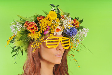 Woman in a stripes sunglasses and wreath of flower
