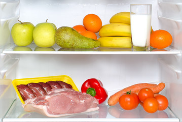 Open fridge full of fruits, vegetables and meat