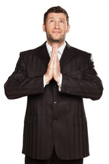 young businessman praying with his hands set in pray