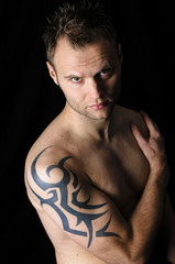 Portrait of a man with tattoos looking at camera